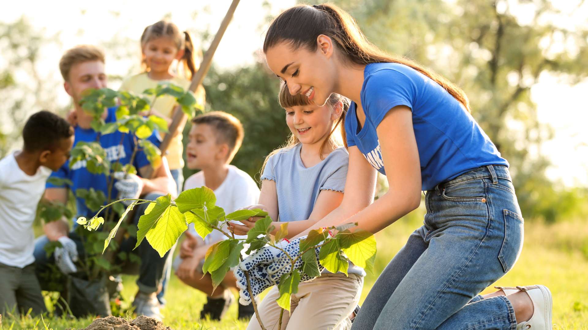 Volunteers gardening together with kids