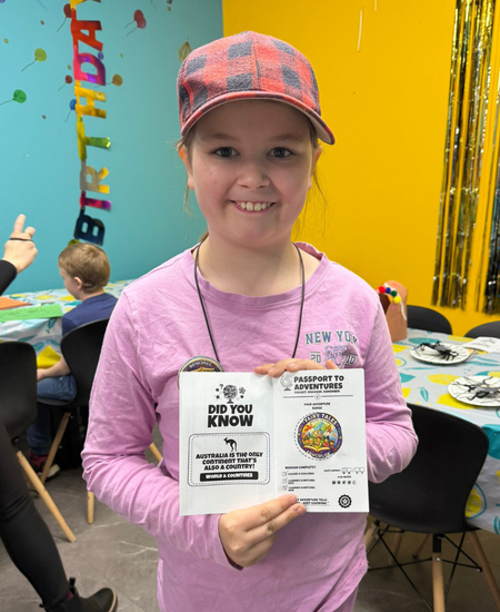 Kid holding Adventure Passport